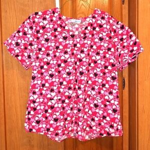 SB Scrubs in a size large. It features black, pink, and white hearts on red top.